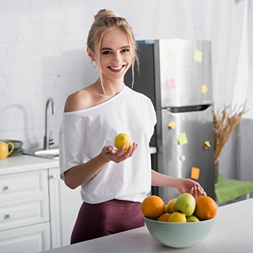 Vrouw met citroen in moderne keuken